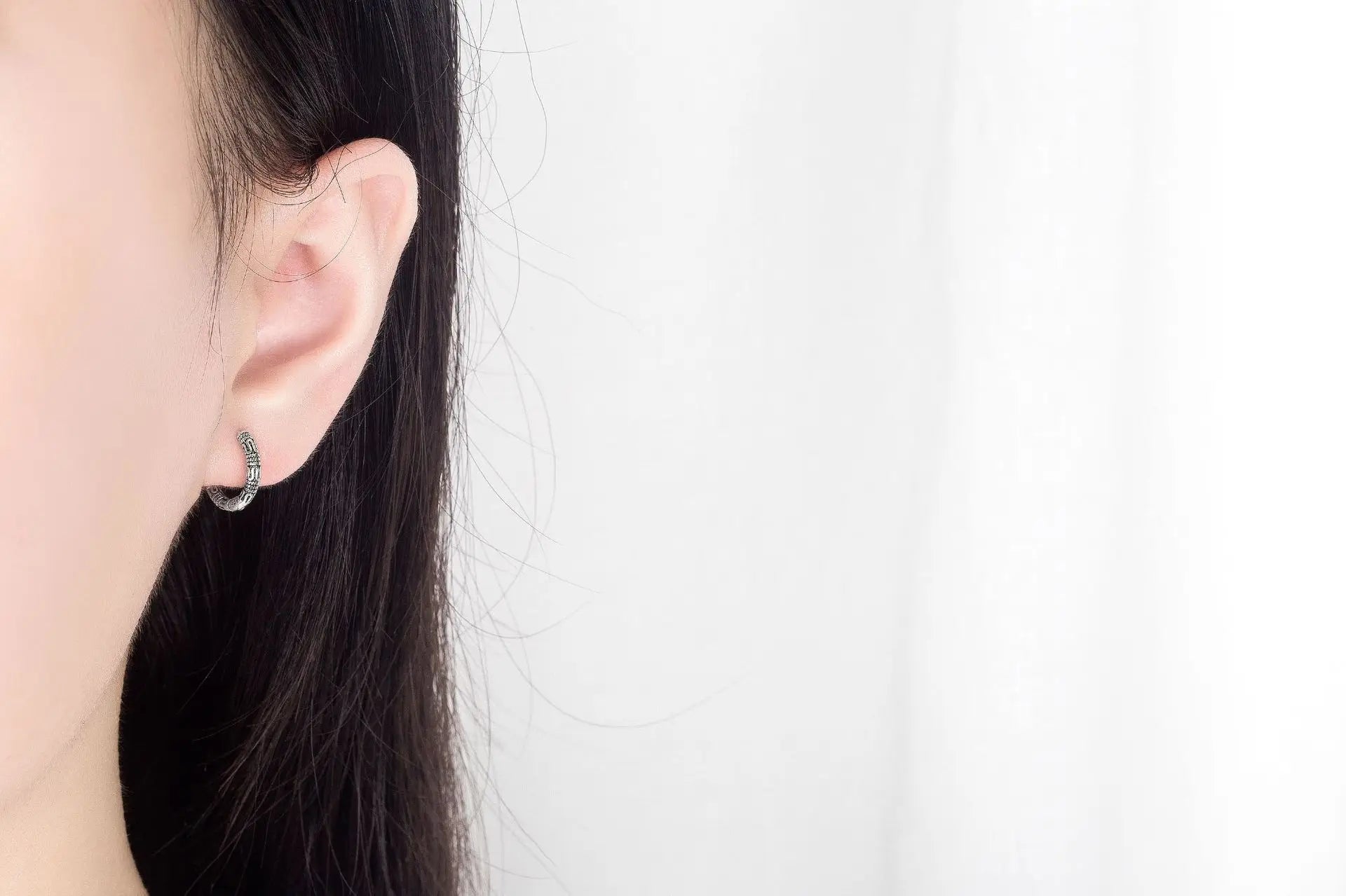 Close-up of Vintage 925 Sterling Silver Hoop Earrings with round pattern design for women.