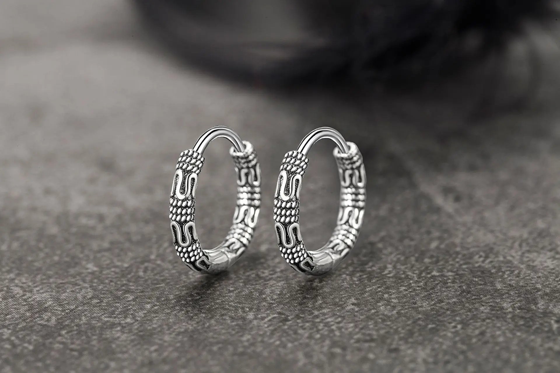 Close-up of Vintage 925 Sterling Silver Hoop Earrings with round pattern design for women.